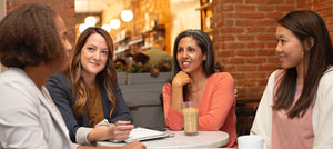 Coworkers seating at a table and having a discussion